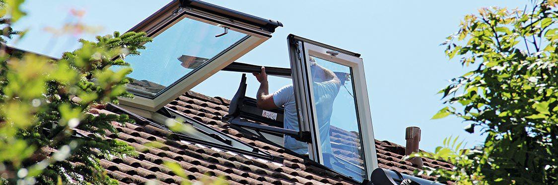 A craftsman assembling the windows on the roof