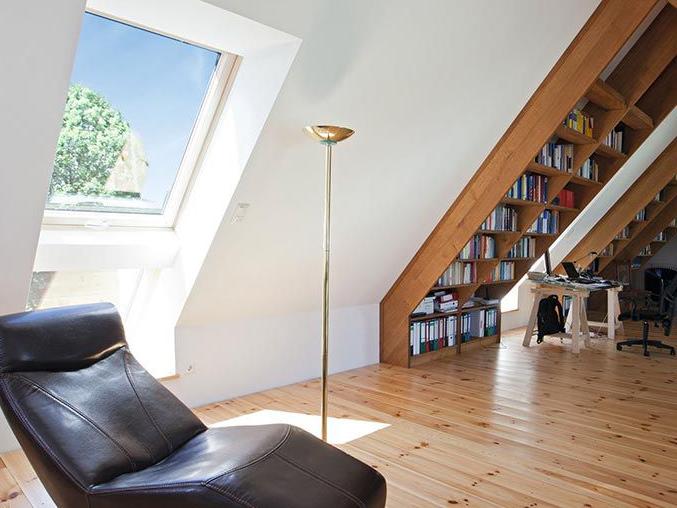 Study with wooden roof window, wooden floor and wooden shelves