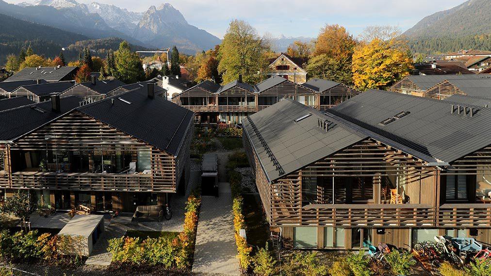 Wooden house settlement with mountains in the background