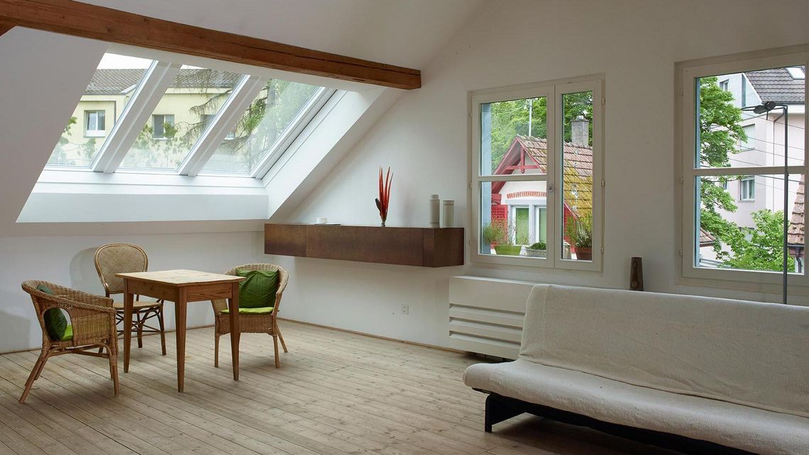 Attic apartment with a closed Azuro panorama roof window 