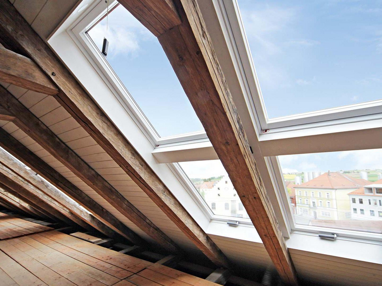 Top floor with old wooden beams and several skylights 