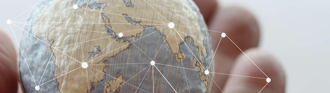 Hand holds globe, drawn lines representing a net