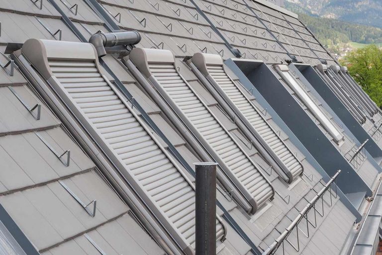 A series of roof windows with shut down external roller shutters
