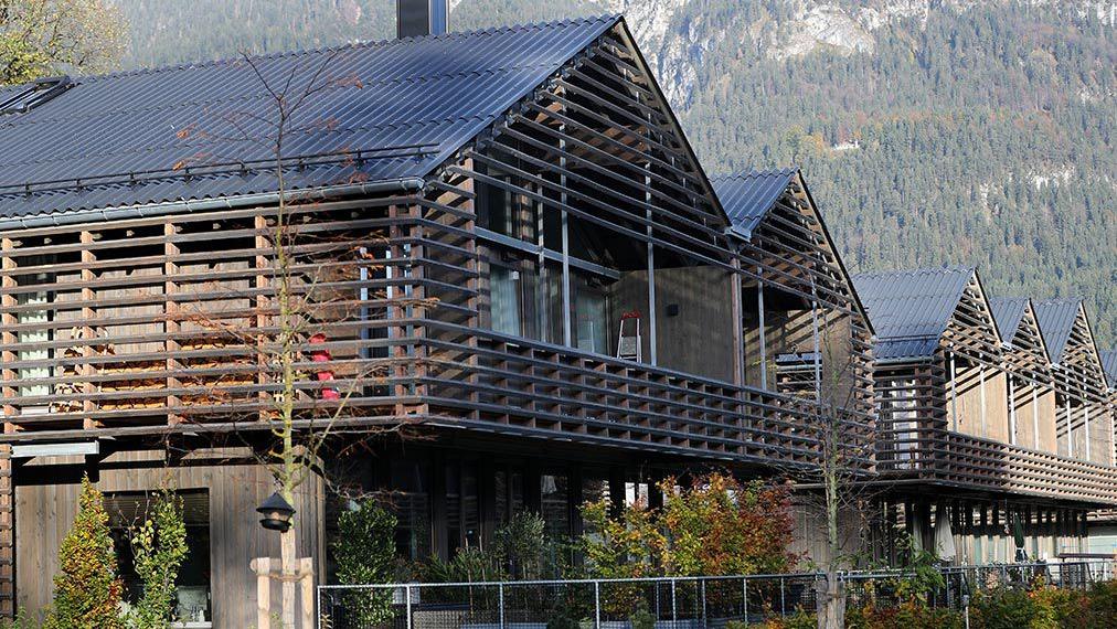 Wooden house settlement with mountains in the background