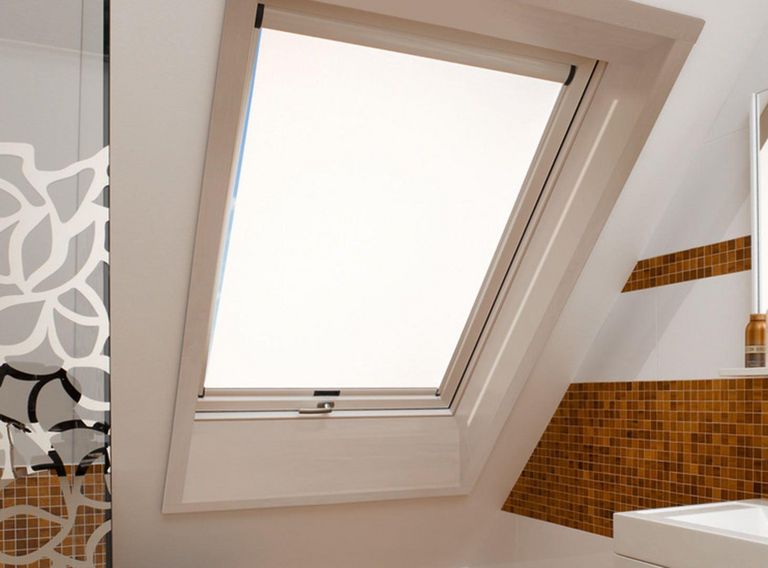 Bathroom with one skylight window and closed daylight roller blind