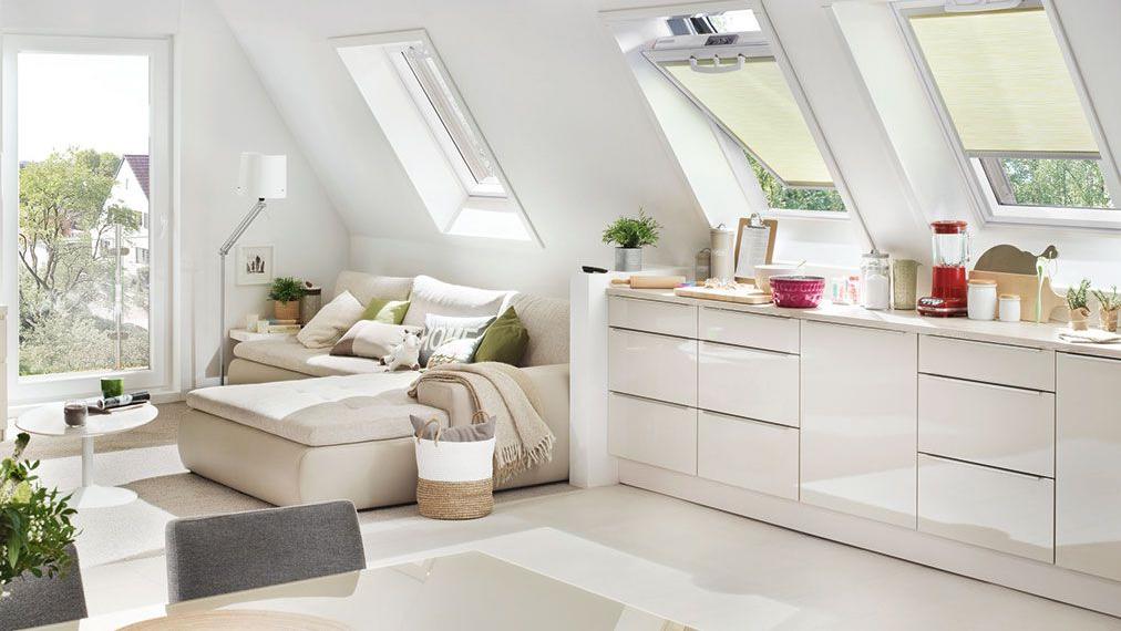 Living and cooking area of an attic apartment with RotoQ swing windows and Exclusiv roller blind