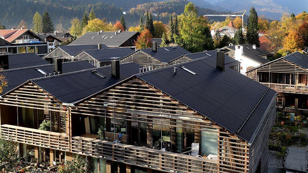 Wooden house settlement with mountains in the background